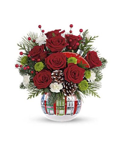 <p>There’s something quietly magical about a snowy winter night—the kind that wraps the world in stillness, warmth, and wonder. This enchanting floral arrangement brings that feeling to life, offering a serene and heartfelt way to share the spirit of the season with someone you love. Whether you're sending comfort, gratitude, or a joyful holiday message, this bouquet carries the peaceful charm of a quiet Christmas Eve.</p>
<p>A rich mix of deep red roses, petite white carnations, and bright green button chrysanthemums forms the heart of this seasonal design. Accented with aromatic sprigs of fir, pine, and cedar, these festive blooms create a vivid contrast of color and texture. The combination of lush greenery and classic holiday tones evokes a cozy, wintery landscape—just like the ones we dream of during the holidays.</p>
<p>The flowers arrive in a delightful ceramic keepsake container adorned with a quaint snowy village motif. With its charming depiction of cottages and rooftops dusted in snow, this reusable jar doubles as a decorative treasure that can brighten any space throughout the season. Long after the blooms have faded, the container remains a nostalgic reminder of a meaningful gift.</p>
<p>Perfect for friends, loved ones, coworkers, or gracious hosts, this holiday arrangement speaks volumes through its quiet beauty and elegant style. It’s a heartfelt way to say “Merry Christmas,” “Thank you,” or simply “I’m thinking of you” in the most memorable way possible.</p>
<p>This seasonal bouquet is arranged and hand-delivered with care by a local florist. Each design is thoughtfully created using the freshest flowers available, and natural variations may occur. Some blooms may arrive in bud form to ensure longer-lasting enjoyment as they open to full splendor.</p>