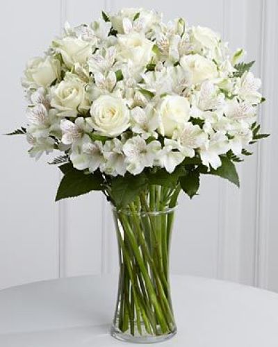<p>When hearts are heavy with loss, simple acts of kindness can provide profound comfort. This serene bouquet offers a peaceful and elegant expression of sympathy, designed to bring light and warmth during difficult times.</p>
<p>The arrangement features pure white roses and soft Peruvian lilies, symbols of remembrance, reverence, and enduring friendship. White roses convey honor and respect, while lilies suggest renewal and the promise of peace. Surrounding lush greenery creates an airy, calming composition that reflects grace and compassion.</p>
<p>Expertly hand-arranged in a clear glass vase, this bouquet is ideal for sending condolences to friends, coworkers, or loved ones who are grieving. Its neutral palette and timeless design suit formal services or personal delivery to the home, serving as a lasting reminder of heartfelt support.</p>
<p>This bouquet is especially fitting for honoring the loss of a close friend, neighbor, or gentle soul who brought kindness and peace to others. It speaks with quiet strength and sincere love, providing a meaningful way to show you care when words are not enough.</p>
<p>Carefully prepared and delivered with compassion, this arrangement arrives fresh and beautiful, ready to offer comfort with dignity and tenderness. It serves as a lasting tribute to cherished memories and a beacon of light in times of sorrow.</p>