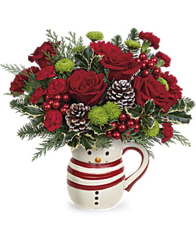 <p>Share a smile and a warm embrace this winter with a bouquet that captures the heart of the holidays. Bursting with charm and good cheer, this joyful arrangement brings the spirit of the season to life in a fun and heartwarming way. Whether you're sending love from afar or adding festive color to someone's holiday table, this thoughtful gift is sure to melt hearts and spark joy.</p>
<p>Cheerful red carnations and miniature red carnations form a vibrant base, accented by green button spray chrysanthemums that add a playful pop. Seasonal touches like noble fir, cedar, and variegated holly give the bouquet a rich, fragrant texture evocative of wintry evergreens. Each bloom is artfully arranged to reflect the warmth and wonder of the holiday season.</p>
<p>What makes this gift truly memorable is the keepsake snowman mug—a ceramic container featuring a jolly smile and cozy red scarf. More than just a vase, it becomes a delightful holiday accent they can use all season long. Perfect for holding cocoa, pens, or candy canes, this charming snowman mug adds a playful touch to any desk or kitchen counter.</p>
<p>Ideal for family, friends, neighbors, or coworkers, this festive bouquet is a cheerful way to say “thinking of you,” “happy holidays,” or simply “sending a hug.” It's a versatile gift that delivers warmth, nostalgia, and a bit of magic to anyone on your nice list.</p>
<p>Each arrangement is handcrafted with the freshest flowers available. Substitutions may occur to maintain quality and ensure timely delivery. Some flowers may arrive in bud form to preserve their beauty and longevity.</p>
<p>Send a snowman full of smiles this season—a bouquet that blends holiday blooms with a keepsake they’ll treasure long after the last snowflake falls.</p>