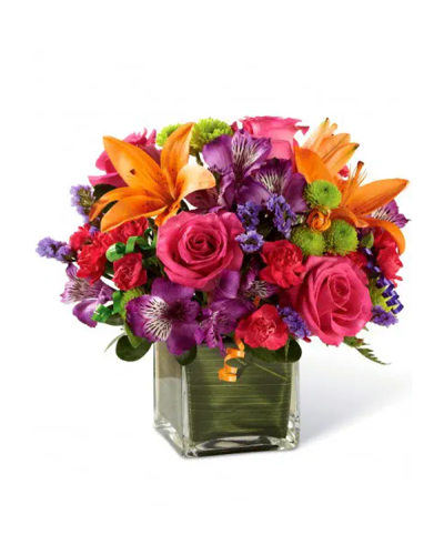 <p>Start the celebration with a bouquet that’s as bright and joyful as the occasion itself. This energetic arrangement is designed to turn birthdays into unforgettable moments, bursting with vibrant color and playful details that bring instant smiles. It’s the perfect way to say, “Let the party begin.”</p>
<p>The bouquet includes a bold mix of hot pink roses, orange Asiatic lilies, purple Peruvian lilies, hot pink mini carnations, green button poms, and purple statice. Each flower is selected for its vivid hue and fresh texture, creating a dynamic composition full of life and movement. Lush greens and curling party ribbons add a festive flair, while the clear glass cube vase—lined with a ti leaf wrap—offers a stylish and modern presentation.</p>
<p>Perfect for birthday celebrations of any age, this design captures the spirit of fun and festivity. Whether you’re sending it to a friend, family member, or colleague, it delivers your best wishes with charm and personality. The mix of colors and textures makes it a standout centerpiece or thoughtful surprise that brings the party wherever it goes.</p>
<p>Every arrangement is thoughtfully handcrafted using fresh, high-quality blooms that are designed to leave a lasting impression. From the vivid palette to the polished vase, each detail is chosen to elevate the moment. The compact cube shape makes it easy to display on desks, tables, or countertops, adding cheer to both home and office settings.</p>
<p>Let this bouquet bring bold color and happy energy to someone’s big day. With its festive styling and joyful composition, it’s more than just flowers—it’s a celebration in bloom, ready to deliver laughter, cheer, and lasting memories.</p>