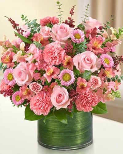 <p>Honor the life of a loved one with a tribute that speaks to warmth, love, and gentle remembrance. The Treasured Memories Bouquet in pink is a comforting gift that offers beauty in a time of sorrow, helping to express emotions that words cannot capture.</p>
<p>This vibrant pink arrangement features a graceful mix of fresh roses, spray roses, snapdragons, alstroemeria, carnations, asters, and heather. Each bloom is hand-selected for quality and color harmony, then paired with lush greens including variegated pittosporum, salal, and spiral eucalyptus. The flowers are thoughtfully arranged in a clear glass cylinder vase and finished with a Ti leaf ribbon for a soft, modern presentation.</p>
<p>This bouquet is a fitting gesture for memorial services, funeral homes, or as a heartfelt delivery to the home of someone grieving. Its cheerful pink tones offer a reminder of the love and joy their memory brings, making it a versatile and comforting expression of sympathy.</p>
<p>Expertly handcrafted and hand-delivered by trusted local florists, this bouquet is available for same-day delivery to ensure your message arrives when it matters most.</p>