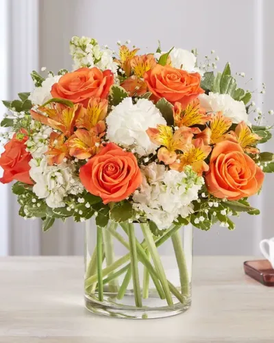 <p>Send a burst of sunshine with the Sweet Citrus Bouquet—a vibrant floral arrangement that radiates joy and charm. With its lively mix of orange, white, and soft yellow blooms, this bouquet is the perfect way to celebrate life’s happiest moments or simply lift someone’s spirits. Whether it’s a birthday, a thank-you, or just because, this cheerful design makes every day feel a little brighter.</p>
<p>This fresh and energetic bouquet features orange roses, peach carnations, creamy white lilies, and soft alstroemeria. Lemon-yellow spray roses and white daisies add playful touches, while fresh greenery provides light texture and balance. The blooms are hand-arranged in a clear glass cylinder vase, offering a clean, modern presentation that allows each flower’s natural beauty to shine.</p>
<p>Sweet Citrus is an ideal choice for celebrations, new beginnings, housewarmings, or any occasion where you want to share happiness. The sunny color palette brings warmth and brightness to any setting—from a kitchen table to a home office or bedside stand.</p>
<p>Each bouquet is crafted with care by skilled local florists using fresh, seasonal blooms. Some flowers may arrive in bud form to ensure lasting enjoyment. Local delivery guarantees that your floral gift arrives fresh, beautiful, and ready to impress.</p>
<p>Celebrate the sweet moments with the Sweet Citrus Bouquet—a colorful and uplifting gift designed to make someone smile.</p>