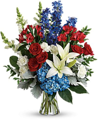 <p>Honor a life well lived or celebrate a patriotic occasion with a vibrant and meaningful bouquet that blends red, white, and blue blooms in a graceful, uplifting design. Whether commemorating a loved one or expressing gratitude to someone who served, this bouquet offers a beautiful and dignified tribute.</p>
<p>The bouquet features a striking mix of red roses, white Asiatic lilies, blue hydrangea, red alstroemeria, white carnations, blue delphinium, and white snapdragons. Accented with huckleberry, dusty miller, aralia leaf, and lemon leaf, the arrangement offers rich texture and fullness. Every flower is hand-selected and expertly arranged in a classic gathering vase, creating a display that is both bold and serene.</p>
<p>Ideal for memorial services, Veterans Day, Independence Day celebrations, or simply honoring someone special, this bouquet carries powerful symbolism. The red blooms express love and respect, white represents peace and remembrance, and blue reflects strength and dignity. Together, they form a touching tribute that speaks volumes when words alone are not enough.</p>
<p>Each arrangement is carefully handcrafted with attention to detail and made fresh to order. Same-day delivery is available locally, ensuring your gift arrives on time and in perfect condition. Whether sending to a home, church, or event, you can trust the florist to deliver with care and precision.</p>
<p>You can add a personal message at checkout to make your tribute even more meaningful. Whether celebrating a proud tradition or remembering a cherished loved one, this bouquet honors the moment with grace and beauty.</p>
