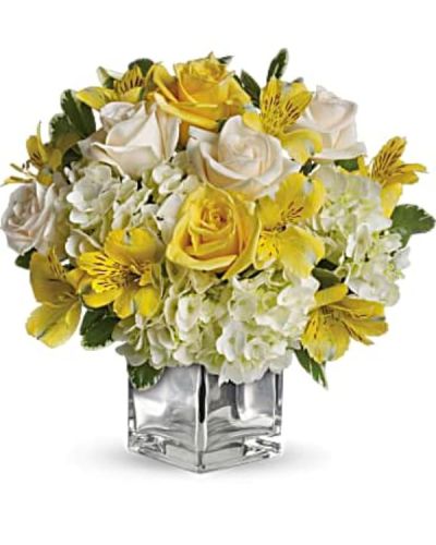 <p>Bring joy to their morning and light to their heart with a glowing bouquet designed to lift spirits and brighten any space. With soft, sunlit tones and a sleek modern presentation, this arrangement delivers happiness with elegance and style.</p>
<p>This cheerful design features a harmonious blend of white hydrangea, light yellow roses, crème roses, and sunny yellow alstroemeria. Fresh greenery adds a natural balance to the palette, while the bouquet is arranged in a contemporary glass cube with a mirrored silver finish that reflects light beautifully and adds a touch of sophistication.</p>
<p>This bouquet is ideal for birthdays, thank-you gifts, congratulations, or just to make someone smile. Its uplifting colors and refined look make it a versatile choice for any occasion that calls for warmth and grace. Whether sent to a home or office, it is sure to be a day-brightener.</p>
<p>Each bouquet is hand-arranged with care by expert florists to ensure freshness, quality, and thoughtful presentation. Same-day delivery is available to bring your gift fresh and beautifully crafted.</p>
<p>Add a heartfelt message during checkout to personalize your gift. Send beauty, optimism, and joy all in one stunning arrangement that makes any day a little brighter.</p>