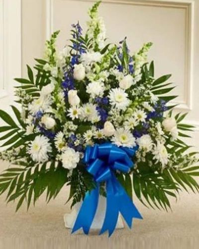 <p>In times of sorrow, a thoughtful floral tribute can offer a moment of comfort and serenity. The Touching Tribute Floor Basket in blue and white is an elegant expression of sympathy, crafted to honor a cherished life with grace and dignity.</p>
<p>This refined arrangement features a soothing blend of white roses, snapdragons, and carnations, paired with striking blue delphinium and complementary seasonal blooms. Designed in a traditional floor basket, the palette of soft blues and whites creates a calming and respectful presence at any memorial service.</p>
<p>Blue flowers symbolize peace, faith, and tranquility, while white flowers reflect purity and eternal rest. This arrangement is appropriate for sending directly to funeral homes from family, friends, or business associates, offering a heartfelt reminder that their memory lives on.</p>
<p>Each Touching Tribute Floor Basket in blue and white is handcrafted by skilled florists with care and professionalism. Same-day delivery is available throughout local communities, ensuring every order is handled with the utmost attention.</p>
<p>Include a sympathy message at checkout to personalize your gift. With its graceful design and comforting colors, this basket helps you express your love, respect, and support when it is needed most.</p>
