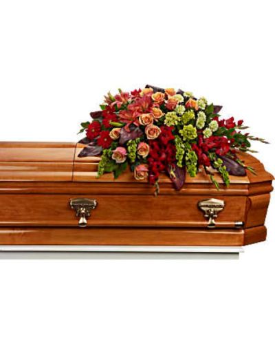 <p>Celebrate a vibrant life with a stunning casket spray that radiates warmth, color, and heartfelt remembrance. Designed to bring majesty and beauty to the service, this bold arrangement is a touching tribute for someone whose presence lit up every room and left lasting memories in the hearts of those they loved.</p>
<p>This magnificent spray features a rich blend of green miniature hydrangea, orange roses, and deep orange Asiatic lilies. Red gerberas and gladioli add dramatic flair and depth, while green carnations and bells of Ireland offer fresh texture and symbolic hope. Accented with lush greenery, this full, cascading design creates a dynamic and uplifting presentation atop the casket, honoring a life of joy, strength, and passion.</p>
<p>This spray is ideal for services where celebration and remembrance come together. The warm tones of orange and red symbolize admiration and devotion, while the fresh green elements suggest renewal and eternal love. It is especially fitting for honoring someone with a bold spirit, generous heart, and vibrant legacy.</p>
<p>Each arrangement is handcrafted with care by experienced florists. Same-day delivery is available to local funeral homes and service venues to ensure your tribute arrives fresh, full, and presented with dignity and compassion.</p>
<p>Include a personal message of remembrance at checkout to accompany your floral gift. Honor a truly unforgettable life with a vivid and beautiful tribute that expresses love, gratitude, and farewell.</p>