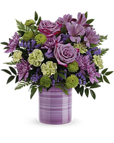 <p>Make her day unforgettable with a gift that blends floral beauty with artistic charm. The Whimsical Swirls Bouquet features a hand-painted vase adorned with playful purple stripes, perfectly paired with a bouquet that feels just as joyful and unique as she is.</p>
<p>This cheerful arrangement showcases lavender roses, vibrant purple alstroemeria, and miniature green carnations. Green button spray chrysanthemums, lavender sinuata statice, huckleberry, and leatherleaf fern add rich texture and lush greenery, all carefully arranged to complement the whimsical design of the keepsake vase.</p>
<p>Perfect for Mother’s Day, birthdays, or any occasion where you want to show love and appreciation, this bouquet brings color, personality, and heartfelt meaning in every stem. And once the flowers fade, the charming vase becomes a lasting reminder of your thoughtful gesture.</p>
<p>Each bouquet is handcrafted by skilled local florists using the freshest seasonal blooms. Some flowers may arrive in bud form to extend their beauty over time. Local delivery is available, ensuring your gift arrives fresh, full of joy, and ready to brighten her day.</p>
<p>Send the Whimsical Swirls Bouquet today and share a moment of love, creativity, and celebration.</p>