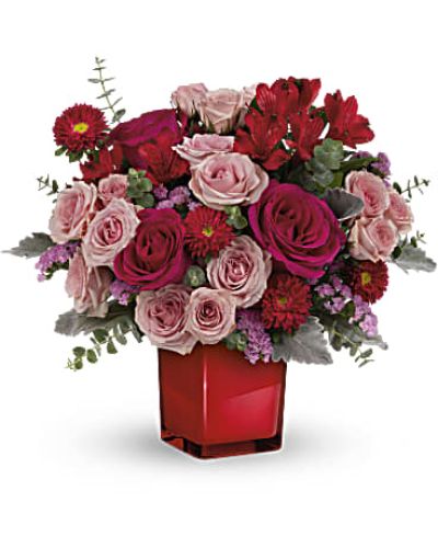 <p>Make a bold and beautiful statement with the Loving Bunch Bouquet—a vibrant floral design that speaks straight from the heart. Overflowing with passionate reds and playful pinks, this bouquet captures emotion in every petal. Whether you're celebrating a birthday, expressing admiration, or sending a romantic surprise, it’s the perfect way to say “I’m thinking of you.”</p>
<p>This eye-catching arrangement features hot pink roses, delicate pink spray roses, red alstroemeria, and red Matsumoto asters. Pink sinuata statice adds a gentle burst of color, while dusty miller and spiral eucalyptus introduce soft texture and cool-toned contrast. The bouquet is presented in a sleek crimson glass cube vase, which glows with contemporary elegance and can be reused as a stylish candleholder or accent piece.</p>
<p>The Loving Bunch is ideal for anniversaries, Valentine’s Day, Galentine’s celebrations, or anytime you want to brighten someone’s day with color and affection. Its bold palette and artistic design deliver a fashionable twist on traditional romantic flowers—perfect for making a lasting impression with style and sentiment.</p>
<p>Each bouquet is carefully handcrafted by local floral designers using fresh, seasonal blooms. Some flowers may arrive in bud form for extended enjoyment. Local delivery ensures your gift arrives fresh, vibrant, and beautifully arranged.</p>
<p>Send the Loving Bunch Bouquet today to share heartfelt emotion with color, style, and undeniable charm.</p>
