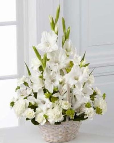 <p>When words feel too heavy, this arrangement speaks gently through soft colors and a serene design. It offers a beautiful way to show someone your thoughts and prayers during a time of grief.</p>
<p>The bouquet features a calming collection of white blooms symbolizing purity, remembrance, and eternal love. Tall white gladiolus add elegance and stature, while clusters of white Peruvian lilies, traditional carnations, and miniature carnations bring softness and depth. Layered greenery adds texture and structure, completing the design with natural balance and grace.</p>
<p>Presented in a round whitewashed handled basket, the arrangement feels comforting and enduring. Its classic style suits funeral services, wakes, or delivery to the home of the bereaved. The basket’s neutral tone and gentle curves express warmth and humility, making it a heartfelt sympathy gesture.</p>
<p>Each sympathy arrangement is handcrafted with care and attention. Same-day local delivery is available, with every order handled respectfully and thoughtfully. Whether honoring a friend, colleague, or family member, this arrangement delivers beauty and meaning when it matters most.</p>
<p>This peaceful tribute brings light to difficult moments and reminds the recipient they are surrounded by love and support even in sorrow. Add a personal message during checkout to share comfort and remembrance with this graceful floral gift.</p>