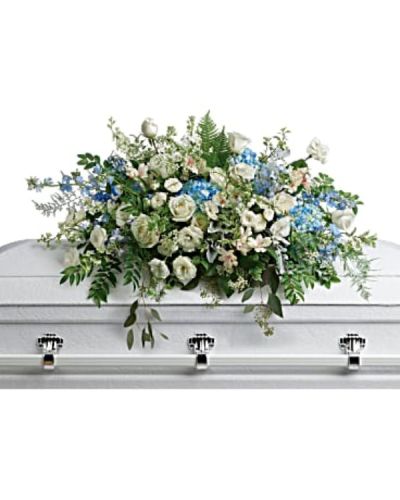 <p>Celebrate the memory of a loved one with a breathtaking standing spray designed to bring comfort, serenity, and a sense of gentle renewal. Like soft clouds drifting through a peaceful sky, this arrangement blends cool blues and crisp whites into a harmonious expression of love, remembrance, and eternal peace.</p>
<p>This elegant spray features soothing blue hydrangea and delphinium, paired with graceful white roses, spray roses, and alstroemeria. Accents of white lisianthus, larkspur, stock, and waxflower add texture and movement, while airy dusty miller and asparagus plumosus offer a soft, ethereal finish. Lush greens—including huckleberry, pitta negra, lily grass, dagger fern, and lemon leaf—complete the arrangement with natural balance and fullness. Designed on a standing easel, this piece brings a tranquil presence to any funeral or memorial service.</p>
<p>This spray is a meaningful tribute for honoring someone whose life brought calm, wisdom, and quiet strength. Its sky-toned palette conveys peace, hope, and the promise of lasting memories. It is especially suited for those who found joy in nature, serenity, or spiritual reflection.</p>
<p>Each arrangement is handcrafted with care and compassion by experienced florists. Same-day delivery is available to funeral homes, places of worship, and service locations to ensure your tribute arrives fresh, full, and ready to honor the life of someone dearly missed.</p>
<p>Add a message of sympathy at checkout to share your thoughts and love with the family. Express what words cannot—with flowers that reflect the soul and beauty of the one you remember. This spray is a quiet, powerful expression of love that lives on.</p>