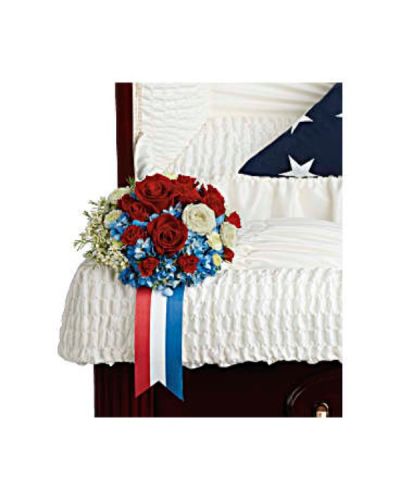<p>Celebrate a life of service and pride with a dignified floral arrangement that reflects deep respect, gratitude, and enduring love. Designed to adorn the casket, this striking blend of red, white, and blue blooms serves as a proud display of patriotism and a touching tribute to a legacy built on honor.</p>
<p>This elegant arrangement features vivid blue hydrangea paired with classic red roses and red spray roses, symbolizing courage and devotion. White spray roses, button spray chrysanthemums, and delicate waxflower add softness and balance, representing peace, purity, and remembrance. Accented with rich green galax leaves, the bouquet forms a refined and heartfelt design that rests gracefully on the casket.</p>
<p>This arrangement is ideal for honoring a veteran, active service member, or anyone who lived with pride in their country. The colors reflect the American flag, making it especially fitting for military services, patriotic memorials, and celebrations of a life lived with purpose and integrity.</p>
<p>Each piece is carefully handcrafted with care and compassion by floral experts. Same-day delivery is available to local funeral homes and memorial venues to ensure your tribute arrives fresh and beautifully arranged.</p>
<p>Include a personal message of remembrance at checkout to accompany this meaningful tribute. Pay respects with flowers that reflect both heart and heritage in a proud and beautiful farewell.</p>