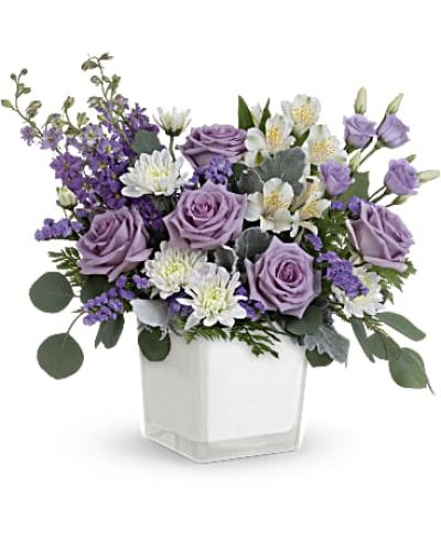 <p>Treat someone to a moment of calm, elegance, and luxury with the Lavender Blooms Bouquet—a graceful arrangement that turns any day into something special. With its soft purple hues and refined silhouette, this bouquet evokes serenity and style in perfect harmony. Whether you're sending a thoughtful gift, celebrating a milestone, or simply brightening a room, Lavender Blooms delivers beauty with quiet charm.</p>
<p>This soothing design features a blend of lavender roses, white alstroemeria, delicate lisianthus, larkspur, and lavender sinuata statice, accented by white cushion spray chrysanthemums for fullness and texture. Soft greenery including dusty miller, leatherleaf fern, and silver dollar eucalyptus adds balance and structure, enhancing the bouquet’s naturally elegant look.</p>
<p>The flowers are arranged in a modern white glass cube with a soft matte finish, offering understated sophistication and versatility. The container’s minimalist design allows it to be reused as a decorative piece, candle holder, or petite vase—adding long-lasting value to this already thoughtful gift.</p>
<p>Ideal for birthdays, anniversaries, get well wishes, or moments of sympathy, the Lavender Blooms Bouquet speaks gently and sincerely. Its peaceful tones and rich textures create a comforting atmosphere, making it a lovely choice for expressing care and appreciation in any setting.</p>
<p>Each bouquet is handcrafted by expert local florists using fresh, seasonal blooms. Some flowers may arrive in bud form to ensure extended enjoyment. Local delivery is available to ensure your gift arrives fresh, polished, and full of meaning.</p>
<p>Send the Lavender Blooms Bouquet today to share a calming, luxurious expression of thoughtfulness and beauty.</p>