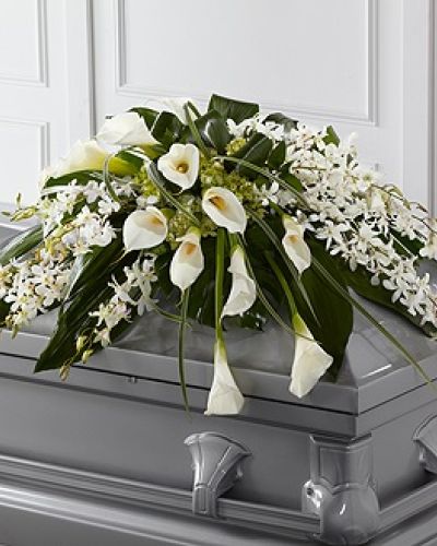 <p>Honor a loved one with elegance and tranquility through this exquisite casket spray. Designed to bring peace and beauty to the final farewell, its soft color palette and flowing, airy design evoke quiet reverence. It serves as a dignified and heartfelt tribute to someone who brought grace and love to those around them.</p>
<p>The arrangement features a sophisticated blend of white Dendrobium orchids and elegant calla lilies, paired with green hydrangea and a lush mix of seasonal greenery. These premium blooms are carefully arranged to rest gracefully atop the casket, creating a full, sweeping design that feels light yet deeply moving. The soft whites and greens symbolize purity, serenity, and eternal love.</p>
<p>Ideal for funeral services, memorials, or celebration of life ceremonies, this casket spray honors a loved one known for their gentle spirit, calming presence, or unwavering strength. Its refined composition conveys profound sentiment in moments when words may fall short.</p>
<p>Each arrangement is handcrafted with care to ensure freshness, beauty, and perfect condition upon delivery. Same-day delivery is available, with coordination through local funeral homes for seamless service.</p>
<p>Add a heartfelt note during checkout to accompany your floral tribute with care and compassion. This casket spray offers a lasting expression of love, remembrance, and peace for those you hold dear.</p>