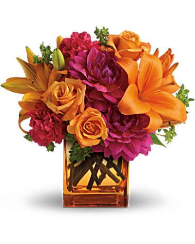 <p>Turn up the heat with this vibrant floral arrangement that captures the essence of summer in full bloom. With its tropical-inspired palette and lively design, this bouquet is pure sunshine in a vase—perfect for adding color and confidence to any celebration.</p>
<p>Hot pink dahlias and carnations bring bold energy, while light orange roses and bright Asiatic lilies add warmth and radiance. The bouquet is accented with fresh green bupleurum and arranged in a modern orange glass cube vase that ties it all together with flair. It’s fresh, fiery, and full of personality.</p>
<p>This bouquet is a fantastic choice for birthdays, summer parties, congratulations, or simply to say “thinking of you” in a bold and unforgettable way. Its striking colors and sleek presentation bring the carefree feeling of a summer getaway into any home or office.</p>
<p>Each bouquet is handcrafted by skilled florists and available for same-day delivery locally. Freshness and expert care are guaranteed without relying on third-party shippers.</p>
<p>Add a heartfelt message during checkout to make your gift even more special. This arrangement is bold, fun, and unforgettable—just like summer itself. Order today to send the ultimate summer statement in floral form.</p>