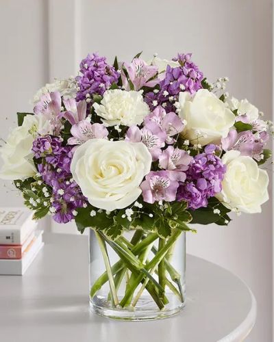<p>Create lasting memories with a thoughtful gift that speaks from the heart. The Lovely Lavender Medley Bouquet is a charming, hand-designed arrangement featuring a gentle mix of lavender and white blooms—crafted to express your deepest sentiments with elegance and warmth.</p>
<p>This soft, graceful design includes a delicate blend of lavender and white flowers, artfully arranged in a clear glass cylinder vase. Cascading greenery adds natural beauty and fluidity to the bouquet, creating a timeless presentation that radiates affection and care.</p>
<p>Perfect for birthdays, anniversaries, or simply letting someone know they’re in your thoughts, this bouquet brings a touch of heartfelt emotion to any occasion. Its tranquil palette and refined composition make it a meaningful gesture for a wide range of celebrations.</p>
<p>Each arrangement is handcrafted by expert local florists using the freshest seasonal blooms. Some flowers may arrive in bud form to extend the enjoyment as they bloom over time. Local delivery is available to ensure your gift arrives fresh, beautiful, and right on time.</p>
<p>Send the Lovely Lavender Medley to brighten someone’s day with soft color, thoughtful design, and timeless charm.</p>