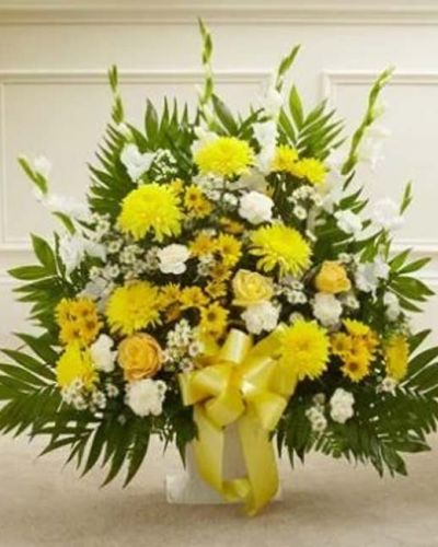 <p>In times of grief, even the smallest light can bring great comfort. This Touching Tribute Floor Basket in yellow offers a warm, uplifting expression of sympathy that shines with hope, remembrance, and heartfelt support. Designed to honor a life and bring peace to those mourning, this arrangement is both elegant and compassionate.</p>
<p>The thoughtful floor basket features a sunny selection of fresh yellow roses, bright yellow cremones, crisp white gladiolas, soft carnations, monte casino, and seasonal greenery. Hand-arranged into a graceful standing display, it brings warmth and serenity to any funeral or memorial setting.</p>
<p>Ideal for friends, family members, or colleagues to send directly to funeral homes, this tribute offers a respectful and dignified way to express condolences. The yellow hues represent friendship, remembrance, and light—making it a comforting gesture during difficult times.</p>
<p>Each floor basket is handcrafted by experienced florists with attention to detail and care. Same-day delivery is available to funeral homes and memorial venues, ensuring the freshest flowers and most thoughtful service.</p>
<p>Including a custom sympathy message at checkout allows you to accompany your gift with words of comfort. Let this bright and elegant tribute help you show support, share in sorrow, and celebrate the life of someone who made the world a little brighter.</p>