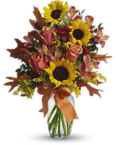 <p>Send a heartfelt hug in floral form with a cheerful bouquet bursting with rustic charm and vibrant fall energy. This sunny arrangement evokes the feeling of a golden afternoon in the countryside—filled with warmth, joy, and beauty. Whether celebrating a special occasion or simply sending a smile, this bouquet wraps your sentiment in a brilliant blend of color and texture.</p>
<p>The bouquet features a joyful mix of golden yellow sunflowers, orange bi-color roses, dark orange alstroemeria, and rust-colored cushion spray chrysanthemums. These radiant blooms are accented with fresh greenery and tied together with a bright orange ribbon that adds a playful finishing touch. Arranged by hand in a classic glass vase, this bouquet delivers visual warmth that feels both rustic and refined.</p>
<p>Perfect for birthdays, thank-you gestures, or fall celebrations, this bouquet speaks the language of joy and affection. Its color palette reflects the rich tones of the harvest season, while the sunny sunflowers and radiant roses offer a universal message of optimism and gratitude. It is also a popular choice for sending comfort or encouragement—like a floral embrace when words fall short.</p>
<p>Each bouquet is carefully handcrafted with attention to detail and made fresh to order. Same-day delivery is available locally, with every arrangement hand-delivered with care—never boxed or outsourced. From farm-fresh stems to thoughtful finishing touches, every order is full of life, love, and attention to detail.</p>
<p>You can add a personal note at checkout to make your gift even more memorable. This bouquet is more than flowers—it is a bright, rustic expression of everything you want to say.</p>