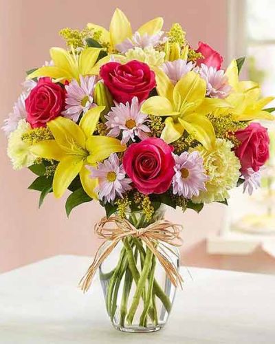 <p>Bring the charm of a European flower market into any space with a bouquet that feels both cheerful and timeless. Overflowing with seasonal color and natural texture, this arrangement captures the warmth and joy of spring in full bloom.</p>
<p>Bright yellow lilies, pink tulips, lavender daisies, purple asters, and green poms come together in a lively mix, accented with filler and fresh greenery for a lush, just-picked look. Arranged in a classic clear glass vase, the bouquet has a hand-tied, market-style feel that’s fresh and full from every angle.</p>
<p>Ideal for spring birthdays, thank-you gifts, or simply celebrating longer days and brighter moods, this bouquet brings garden beauty indoors. Its playful mix of color and structure makes it a standout on kitchen tables, desks, or entryways.</p>
<p>Handcrafted by a local florist and delivered fresh, each bouquet may vary slightly with seasonal availability—but the palette and joyful style remain true to the design.</p>
<p>Celebrate spring with a bouquet that blends old-world charm and modern delight—a gift that feels like a stroll through a blooming European village.</p>
