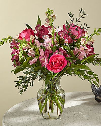 <p>Let the magic of flowers speak from the heart with a bouquet that captures romance, grace, and timeless beauty. Overflowing with soft, feminine hues and lush textures, this enchanting arrangement is the perfect way to celebrate love, mark a special moment, or simply brighten someone’s day with elegant charm.</p>
<p>The bouquet features a captivating mix of soft pink roses, hot pink alstroemeria, and tall pink snapdragons. These blooms are chosen for their romantic appeal and layered tones, blending beautifully into a design that evokes the peaceful beauty of a sunrise garden. Fresh greenery provides natural contrast, allowing the pinks to pop while adding structure and balance to the arrangement.</p>
<p>Presented in a classic clear glass vase, this bouquet’s tall and airy silhouette brings an effortless sense of style to any space. Its vertical lines and varied textures make it an eye-catching centerpiece for tables, desks, or entryways, adding both color and height to the room. The result is a floral display that feels both contemporary and enduring.</p>
<p>This bouquet is ideal for anniversaries, birthdays, congratulations, or romantic gestures. Its soft color palette and elegant presentation make it equally fitting for expressions of affection or appreciation. Whether you’re sending it to a partner, friend, or family member, it delivers beauty and meaning with every bloom.</p>
<p>Each arrangement is handcrafted using fresh, seasonal flowers and delivered with care. While specific blooms may vary slightly depending on availability, the pink theme and romantic style will remain consistent. Share a moment of joy, love, or celebration with a bouquet that brings lasting beauty and heartfelt intention.</p>