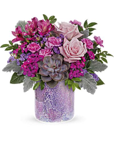 <p>Capture the glow of a desert sunset with a bouquet that radiates elegance and charm. The Lovely Shine Bouquet combines lush pink roses and a striking succulent in a chic, refreshing design—perfect for bringing beauty and joy to any occasion.</p>
<p>This sophisticated arrangement features soft light pink roses, delicate purple alstroemeria, and miniature lavender carnations. Dark pink sweet william and lavender sinuata statice add vibrant accents, while dusty miller and huckleberry provide texture and contrast. A large green echeveria succulent brings a modern, sculptural element to the bouquet. All are arranged in a shimmering mosaic glass vase that reflects light and enhances the bouquet’s radiant appeal.</p>
<p>Ideal for birthdays, anniversaries, or thoughtful surprises, Lovely Shine offers a unique blend of color, form, and style. From its captivating textures to its eye-catching vase, this bouquet makes a lasting impression from the very first glance.</p>
<p>Each arrangement is handcrafted by local florists using the freshest seasonal flowers. Some blooms may arrive in bud form to ensure extended freshness and enjoyment. Local delivery is available for a seamless and memorable gifting experience.</p>
<p>Send the Lovely Shine Bouquet today and let its radiant beauty brighten someone’s world.</p>