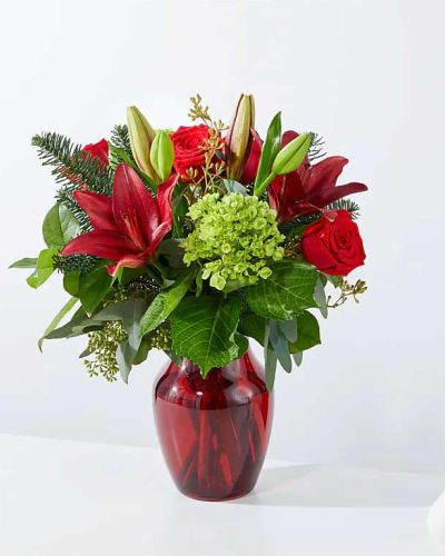 <p>Celebrate the season with a bouquet that captures the warmth, magic, and joy of Christmas. The Merry Days Bouquet is a vibrant blend of festive elegance, designed to bring holiday cheer straight to someone’s doorstep. Whether you’re sending love, expressing gratitude, or decorating your home, this arrangement delivers holiday spirit with every bloom.</p>
<p>Bold red roses take center stage in this rich display, surrounded by lush seasonal greens and coordinating red blooms. The mix of textures and tones creates depth and natural movement, evoking the beauty of a winter forest adorned in holiday splendor. Each flower is hand-selected for freshness, and the arrangement strikes a perfect balance between vibrant color and organic charm.</p>
<p>Ideal for Christmas gatherings, winter birthdays, or thoughtful seasonal gestures, the Merry Days Bouquet is both versatile and heartfelt. Its classic red-and-green palette instantly evokes the holidays, while its full, rounded shape makes it perfect as a centerpiece, mantel accent, or meaningful gift.</p>
<p>Every bouquet is handcrafted by skilled local florists using the freshest seasonal flowers. Some blooms may arrive in bud form to ensure long-lasting enjoyment. Local delivery is available, ensuring your gift arrives fresh, festive, and ready to make the season bright.</p>
<p>Send the Merry Days Bouquet today and brighten someone’s holiday with timeless color, seasonal cheer, and heartfelt beauty.</p>