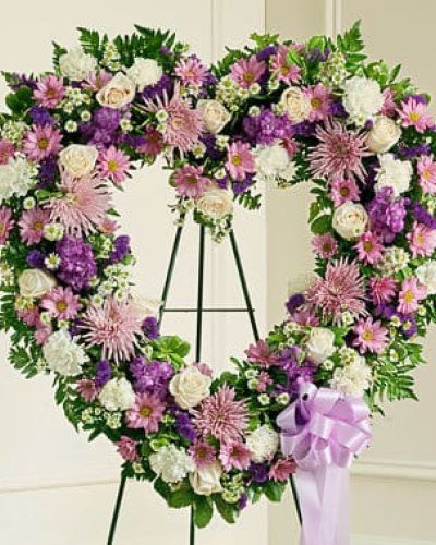 <p>Honor a life filled with love and kindness with the Forever Cherished Floral Heart Tribute in lavender. Thoughtfully designed for moments of remembrance, this heart-shaped standing spray offers a graceful expression of sympathy and the love that lives on in your heart.</p>
<p>Delicately arranged with soft lavender and white blooms, this tribute symbolizes peace, memory, and gentle strength. Each floral heart is handcrafted by expert florists using a thoughtful selection of roses, carnations, mums, and seasonal accents, creating a design that is both comforting and beautifully respectful.</p>
<p>Traditionally sent directly to funeral homes by close friends or family, this standing spray is a meaningful way to celebrate a loved one’s life during memorial services and viewings. Its soft color palette brings a sense of calm and reflection to any gathering.</p>
<p>Every tribute is created with care by trusted florists. Timely, respectful delivery is available to funeral homes across local communities, ensuring each arrangement is presented with grace and dignity.</p>
<p>Add a personal message of condolence at checkout to share your heartfelt words. With the Forever Cherished Floral Heart in lavender, you’re sending more than sympathy—you’re honoring a beautiful life with love and compassion.</p>