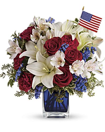 <p>Celebrate the spirit of America with a bouquet that honors courage, unity, and pride. This striking arrangement commemorates national holidays or pays tribute to a brave veteran or loved one who served.</p>
<p>The bouquet features red roses, red carnations, white Asiatic lilies, white alstroemeria, and blue statice. Accented with green pitta negra and seeded eucalyptus, the blooms are arranged in a cobalt blue glass cube and accompanied by a small American flag for a patriotic touch.</p>
<p>Perfect for Memorial Day, Fourth of July, Veterans Day, or military homecomings, this bouquet combines heartfelt symbolism with fresh beauty. Whether displayed at a picnic, given as a tribute, or sent to someone admired, it speaks volumes.</p>
<p>Each bouquet is handcrafted by trusted local florists and available for same-day delivery. Every order is prepared locally and delivered with care and pride.</p>
<p>Add a special note during checkout to personalize your gift. This bouquet is more than flowers—it honors values that matter most. Order today to share a patriotic gesture filled with love, gratitude, and beauty.</p>
