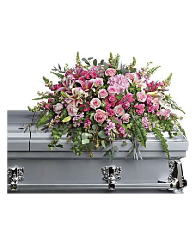 <p>Honor a cherished life with this lush and elegant casket spray that captures the tenderness of heartfelt memories. Overflowing with soft pink blooms and graceful greenery, this floral arrangement symbolizes love, peace, and the enduring beauty of shared moments. It offers comfort to grieving hearts while paying tribute to someone who brought warmth and light into the lives of others.</p>
<p>This breathtaking spray features an artful blend of pink hydrangea, pink roses, and pink spray roses, creating a lush base filled with color and grace. Stargazer lilies add a bold, fragrant touch, while carnations, larkspur, snapdragons, and pink stock bring softness, movement, and texture throughout the design. Green ivy trails gently across the arrangement, complemented by sword fern, silver dollar eucalyptus, seeded eucalyptus, and lemon leaf for a natural and serene finish. The design rests beautifully atop the casket, offering a full and feminine expression of farewell.</p>
<p>Ideal for honoring a beloved mother, grandmother, sister, daughter, or dear friend, this spray evokes feelings of gratitude, admiration, and lasting love. The pink color palette symbolizes gentleness and affection, making it a fitting tribute for someone remembered with deep emotion and reverence.</p>
<p>Each casket spray is handcrafted with care by expert florists, ensuring every stem is placed with intention to create a polished, elegant presentation that respects the importance of the moment. Same-day delivery is available to funeral homes and service locations with attention to timely and respectful service.</p>
<p>Include a personal message of sympathy at checkout to accompany this floral tribute. Honor your loved one with flowers that speak from the heart and reflect the beauty of a life remembered.</p>