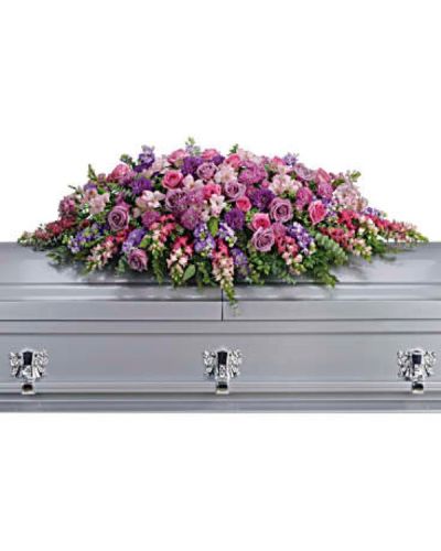 <p>Honor her femininity and generous spirit with a blanket of sweetly scented lavender, pink, and purple flowers that create a magnificent final tribute, sincerely expressing devotion and love. Gorgeous blooms such as lavender and pink roses, pink snapdragons, and alstroemeria combine with purple and lavender chrysanthemums to form a graceful, heartfelt arrangement. These are entwined with eucalyptus, huckleberry, and ming fern, adding texture and natural beauty to the design. This tribute offers a touching expression of affection and remembrance, perfect for celebrating a cherished life.</p>