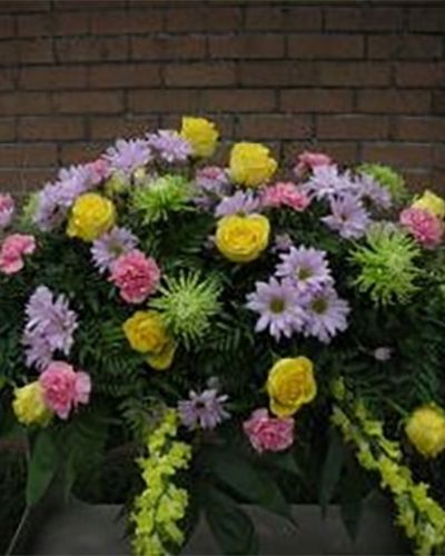 <p>When sorrow fills the air, flowers can provide a gentle presence that offers comfort and compassion. This soft and elegant arrangement serves as a serene tribute to someone dearly loved and deeply missed. Designed to express sympathy with grace, it brings light to a difficult moment while honoring a life remembered for its warmth and kindness.</p>
<p>The spray features a delicate cascade of pastel blooms arranged with care and intention. Pale pink roses and carnations form a tender foundation, while lavender stock and soft purple larkspur add layers of depth and quiet meaning. Creamy lilies and yellow snapdragons offer a soft glow of hope, complemented by lush greenery and subtle filler flowers that complete the arrangement with peaceful harmony.</p>
<p>This design is ideal as a standing spray or presentation piece for memorial services, funeral homes, or places of reflection. Its gentle tones and flowing form offer a beautiful way to pay tribute to a radiant spirit. Whether honoring a loved one from a distance or standing close beside them, this floral display speaks with calm reassurance, inviting a moment of remembrance and peace.</p>
<p>Each spray is carefully arranged with fresh, high-quality blooms that convey both beauty and emotion. The soothing color palette makes it suitable for a wide range of cultures, traditions, and personal sentiments. Crafted to reflect thoughtfulness and care, the arrangement becomes a comforting gesture in a time that calls for quiet strength and heartfelt connection.</p>
<p>Let this pastel tribute provide a message of love and remembrance. With its flowing elegance and peaceful hues, it honors a life lived with grace and offers comfort to those who gather to reflect, remember, and say goodbye.</p>