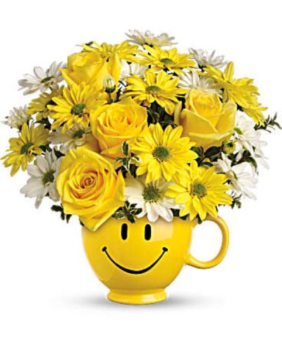 <p>Send a cheerful pick-me-up that radiates warmth and positivity with a joyful bouquet designed to brighten anyone’s day. Delivered in a keepsake smiley face mug, this arrangement is guaranteed to bring smiles as wide as its grin. Whether sending encouragement, appreciation, or a surprise to lift spirits, this bouquet makes happiness bloom.</p>
<p>Hand-arranged by expert florists, this sunny design showcases brilliant yellow roses, playful white and yellow daisy spray chrysanthemums, and fresh oregonia accents. The flowers burst with charm and energy, all nestled inside a bright yellow ceramic mug adorned with an iconic happy face. It’s a gift that offers beautiful flowers and a reusable reminder of thoughtfulness.</p>
<p>Perfect for many occasions—thinking of you, get well soon, teacher appreciation, or a cheerful birthday surprise—this bouquet is versatile and heartwarming. Its youthful spirit appeals to kids, while classic daisies and roses bring sunshine to anyone in need.</p>
<p>Each order is carefully prepared with care and delivered by hand, never boxed or outsourced. Same-day local delivery is available through a trusted local florist who puts quality and customer happiness first.</p>
<p>You can add a custom message at checkout to make the delivery even more personal. With same-day service and heartfelt design, this bouquet is the perfect way to send smiles across the miles and brighten someone’s day.</p>