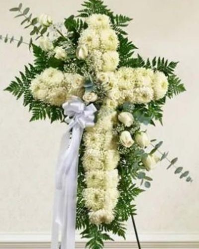 <p>When words cannot express the depth of your love and sympathy, let a timeless symbol of faith and peace speak for you. The Peace & Love Standing Cross in white is a powerful tribute, offering comfort and reverence through the elegant simplicity of an all-white floral cross.</p>
<p>This standing spray is beautifully crafted from pure white roses and lush football mums, accented with fresh greenery and soft floral details. Designed in the shape of a cross and mounted on a supportive easel, it stands tall as a symbol of eternal love, hope, and spiritual peace—perfect for honoring a life rooted in faith.</p>
<p>Whether sent by family, friends, or members of a congregation, this elegant arrangement makes a meaningful statement at memorial services, funerals, or celebrations of life. The all-white color scheme reflects purity, grace, and everlasting remembrance—offering a gentle presence during life’s most sorrowful moments.</p>
<p>Lovingly designed by expert florists with care and precision, each Peace & Love Standing Cross is handcrafted to ensure quality and beauty. Dependable same-day delivery is available to funeral homes and places of worship in local areas.</p>
<p>Include a heartfelt condolence message at checkout to personalize your tribute. When someone you love has passed, this floral cross offers peace, love, and a sacred way to say goodbye.</p>