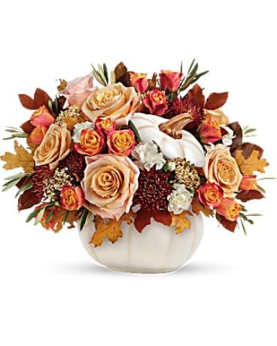 <p>Embrace the cozy elegance of fall with a stunning seasonal arrangement that blends timeless beauty with festive flair. This handcrafted bouquet is designed to warm hearts and homes, featuring luxurious blooms in soft cream and rich autumn tones—all beautifully presented in a white ceramic pumpkin bowl with a removable lid, perfect for seasonal décor even after the flowers fade.</p>
<p>At the heart of this arrangement are elegant cream roses, paired with white miniature carnations for softness and charm. Burgundy cushion spray chrysanthemums bring depth and richness, while yellow cottage yarrow adds texture and a golden autumn glow. Accents of olive branches and copper beech foliage tie the whole look together with a natural, woodland feel that is both sophisticated and welcoming.</p>
<p>Ideal for fall birthdays, Thanksgiving tables, hostess gifts, or simply sending autumnal joy, this arrangement is a heartfelt way to celebrate the season. Its blend of creamy neutrals and rustic harvest colors makes it versatile for any home, and the keepsake pumpkin bowl can be reused year after year—adding beauty and functionality long after the bouquet is enjoyed.</p>
<p>Each bouquet is carefully handcrafted with attention to detail and made fresh to order. Same-day delivery is available locally, ensuring your gift arrives fresh, full, and ready to impress. No boxed flowers or generic service—just local expertise and genuine attention to quality.</p>
<p>You can add a thoughtful message at checkout to personalize your delivery. Whether sending thanks, celebrating a milestone, or simply embracing the season, this arrangement leaves a lasting impression of autumn charm.</p>