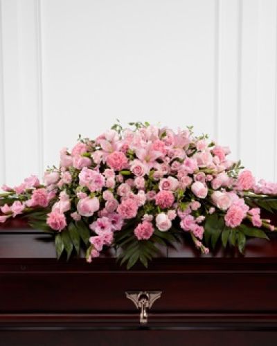 <p>Celebrate the life of someone who brought sweetness and compassion into the world with this elegant casket spray. Thoughtfully designed to rest atop the casket, it honors the memory of a loved one with soft pink blooms and lush greenery that reflect tenderness, grace, and heartfelt love.</p>
<p>The arrangement features a refined selection of pink lilies, gladiolus, roses, and carnations, arranged in a sweeping display that offers both fullness and softness. Each bloom is carefully chosen for its beauty and meaning, creating a tribute that feels personal, gentle, and deeply sincere. Accents of fresh green foliage add balance and richness, enhancing the natural beauty of the flowers and completing the composition with poise.</p>
<p>Ideal for memorial services, funerals, or celebrations of life, this casket spray offers a powerful expression of love and remembrance. Its serene color palette and flowing design make it appropriate for honoring someone known for their kindness, warmth, and inner beauty.</p>
<p>Each arrangement is handcrafted by experienced florists and prepared fresh to order, delivered directly to the funeral home or service location. Same-day delivery is available, and coordination with local funeral providers ensures seamless service.</p>
<p>Add a personal message during checkout to share your love and support. This casket spray is a timeless way to say goodbye, offering comfort and beauty during a difficult time.</p>