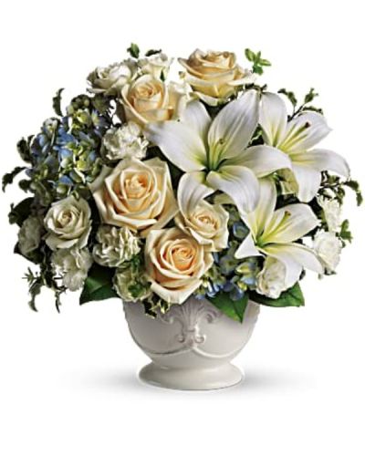 <p>Offer comfort and compassion with a serene sympathy arrangement that brings peace and elegance during difficult times. Styled with soft French country charm, this bouquet is a thoughtful way to share condolences and let loved ones know they are in your thoughts.</p>
<p>This soothing design features blue hydrangea, cream roses, white miniature carnations, and fragrant white asiatic lilies. The gentle color palette of blue, ivory, and white provides a calming presence, while green pitta negra adds soft texture and contrast. The flowers are arranged in a rustic French country pot, offering timeless and understated elegance that complements the sentiment behind the gift.</p>
<p>This arrangement is ideal for sending to family, friends, or loved ones who are grieving, whether delivered to a home or directly to a memorial service. Its graceful presentation and muted tones make it a respectful and comforting expression of sympathy.</p>
<p>Each piece is carefully handcrafted with attention to detail and made fresh to order. Same-day delivery ensures the tribute arrives fresh, beautiful, and on time.</p>
<p>You can include a personal message at checkout to share your thoughts, prayers, or heartfelt memories. This arrangement offers more than flowers—it offers comfort, beauty, and a gentle reminder that love and support are always near.</p>