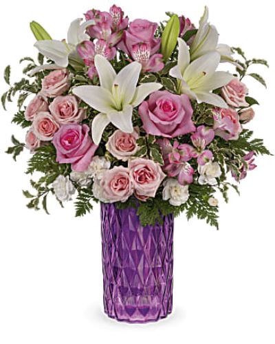 <p>Celebrate someone special with a dazzling gift that speaks the language of love in every shade of pink. The Rose Glam Bouquet is a radiant arrangement designed to show just how much she means to you—blending elegance, charm, and vibrant color in one unforgettable display.</p>
<p>This lush bouquet features a beautiful mix of pink roses, pink spray roses, and soft pink alstroemeria. Accents of pink rice flower, leatherleaf fern, pink limonium, and silver dollar eucalyptus add depth and texture, while a shimmering iridescent pink glass vase completes the look with a glamorous flourish.</p>
<p>Perfect for Mother’s Day, birthdays, or any moment when you want to leave a lasting impression, this bouquet offers a timeless expression of love with a modern, stylish twist. It’s a heartfelt way to brighten her day and show your appreciation.</p>
<p>Each arrangement is handcrafted by experienced local florists using the freshest seasonal blooms. Some flowers may arrive in bud form to ensure a longer-lasting presentation. Local delivery is available for prompt, thoughtful gifting.</p>
<p>Send the Rose Glam Bouquet today to share beauty, love, and a touch of glamour.</p>