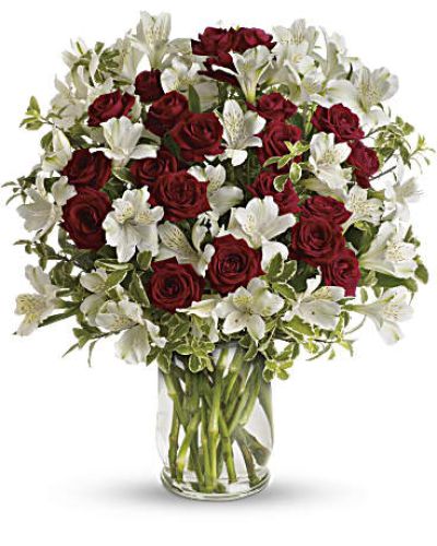<p>When it comes to romance, nothing speaks more beautifully than the classic pairing of red and white blooms. This bouquet captures that sentiment perfectly with passionate red spray roses and delicate white alstroemeria, elegantly arranged in a clear glass hurricane vase. Whether celebrating a special moment or reminding someone how much they mean to you, it offers a heartfelt expression of lasting affection.</p>
<p>The arrangement features vibrant red spray roses symbolizing love and admiration, paired with soft white alstroemeria for balance and beauty. Pitta negra greenery adds texture and contrast, giving the design lush fullness and natural charm. The hurricane vase enhances the presentation with a sleek, modern touch to this timeless floral display.</p>
<p>Ideal for anniversaries, romantic gestures, or thoughtful surprises, this compact bouquet fits perfectly on nightstands, coffee tables, or desks. Its bold colors and thoughtful design ensure a lasting impression.</p>
<p>Each bouquet is handcrafted with care by experienced florists and available for same-day delivery locally. Your gift arrives fresh, full, and ready to enjoy, with personal attention in every detail.</p>
<p>Add a custom message during checkout to personalize your gift. Whether near or far, this bouquet helps you share love in the most elegant way. Order today for same-day flower delivery and make any moment feel timeless.</p>