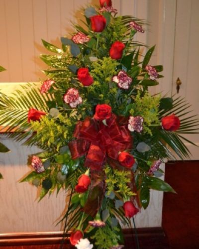 <p>When honoring a life marked by love and grace, a floral tribute can offer powerful expression where words may falter. This standing spray brings dignity and beauty to memorials, funerals, and celebration of life ceremonies. With its vertical elegance and timeless design, it serves as a heartfelt gesture of sympathy and remembrance.</p>
<p>The arrangement features classic roses at its center, symbolizing enduring love and profound respect. They are paired with gently ruffled carnations, blooms long associated with admiration and eternal affection. Depending on seasonal availability, the color palette may include soft pinks, bold reds, serene whites, or thoughtful combinations. Lush greenery surrounds the arrangement, enhancing its depth and creating a natural, flowing silhouette that brings quiet comfort.</p>
<p>This standing spray is designed for placement beside a casket, altar, or photo display. Supported by a sturdy easel, it becomes a focal point in the service space, drawing attention with its soft elegance and emotional resonance. Whether used to honor a parent, partner, grandparent, or friend, it offers a respectful and moving way to express gratitude, love, and farewell.</p>
<p>Each spray is carefully arranged with fresh, premium flowers chosen for both their beauty and meaning. The thoughtful balance of form and color helps communicate a message of peace, appreciation, and connection. It stands as a tribute not only to the life lived but also to the legacy left behind—offering beauty amid sorrow and comfort in a time of reflection.</p>
<p>Let this graceful standing spray serve as a lasting symbol of remembrance. Through its timeless blooms and thoughtful design, it provides a quiet, sincere expression of love and reverence for someone who will always be deeply missed.</p>