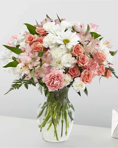 <p>Delicate, dreamy, and undeniably romantic—the Blush Crush Bouquet is a tender expression of affection, perfect for celebrating love, friendship, or joyful moments. With its soft pinks, creamy whites, and fresh greenery, this arrangement brings a graceful charm that’s sure to make anyone smile.</p>
<p>The bouquet features a lovely mix of blush-toned flowers, including pink roses, pale pink spray roses, and soft white lilies or alstroemeria. White chrysanthemums and subtle accent blooms add fullness and texture, while fresh greenery brings movement and balance. Arranged in a classic glass vase, this bouquet feels effortlessly elegant with a clean, modern touch.</p>
<p>Ideal for anniversaries, birthdays, engagements, or just because, Blush Crush fits beautifully into any setting. Its gentle colors and lush design make it a timeless favorite for bedside tables, kitchen counters, or special celebrations, delivering warmth and beauty with every petal.</p>
<p>Expertly arranged by a local florist using the freshest seasonal blooms, this bouquet is hand-delivered with care. Some flowers may arrive in bud form for longer enjoyment and a stunning unfolding experience.</p>
<p>Send the Blush Crush Bouquet today—a soft and beautiful way to brighten someone’s day and share a heartfelt message of love or appreciation.</p>