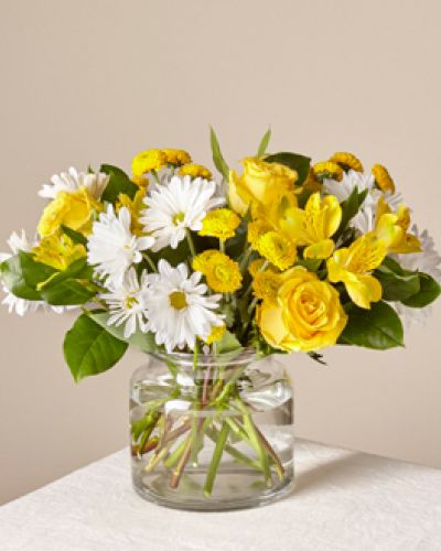 <p>When words fall short, flowers offer a graceful and beautiful way to express care. This bouquet serves as a radiant reminder that a simple gesture can bring warmth, cheer, and comfort to someone’s day. Its fresh blooms and uplifting palette brighten every occasion with genuine kindness.</p>
<p>The arrangement features a vibrant blend of yellow and white flowers that evoke the warmth of sunlight filling a room. Sunny yellow lilies and roses bring golden tones of happiness, while crisp white daisies and complementary blooms add a soft, peaceful balance. Together, they capture optimism, hope, and heartfelt wishes.</p>
<p>Ideal for sending support to someone recovering from illness, lifting spirits during difficult times, or celebrating milestones like birthdays and promotions, this bouquet conveys the message “you matter.” Its bright hues and lively presence express positivity and affection in a meaningful way.</p>
<p>Each bouquet is carefully hand-delivered with attention to quality and detail. Designed to arrive fresh and beautiful, it offers a sincere expression of sentiment that resonates deeply with recipients.</p>
<p>Bring light and joy into someone’s life with this cheerful bouquet. Perfect for celebrations, encouragement, or simply because, it lets your heartfelt sentiments shine through every bloom.</p>