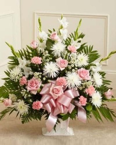 <p>When it’s hard to find the right words, let the quiet beauty of flowers speak for you. The Touching Tribute Floor Basket in pink and white is a heartfelt expression of sympathy, offering peace, admiration, and comfort during times of loss.</p>
<p>This elegant arrangement features fresh pink roses, white spider mums, white snapdragons, pink carnations, and additional seasonal blooms. Carefully arranged in a traditional floor basket, the soft pink and white color palette creates a serene and uplifting presence. The pink symbolizes gratitude and love, while the white conveys purity, peace, and reverence.</p>
<p>Ideal for sending directly to funeral homes, this tribute is appropriate for family members, close friends, or professional acquaintances. It serves as a graceful reminder of the love shared and the legacy left behind.</p>
<p>Each Touching Tribute Floor Basket in pink and white is handcrafted by expert florists with care and attention to detail. Same-day delivery is available throughout local areas, ensuring your arrangement arrives fresh and with the care it deserves.</p>
<p>Include a sympathy message at checkout to personalize your gift. With its gentle tones and elegant design, this basket offers a comforting way to honor a life and show your heartfelt support.</p>