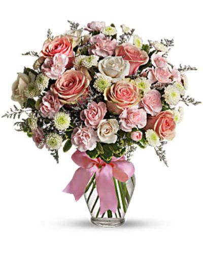 <p>Send a light and lovely surprise with a playful arrangement that captures the soft, dreamy feeling of a spring day. With sweet pastel tones and delicate blooms, this bouquet is perfect for anyone who loves flowers that are pretty, pink, and full of joy.</p>
<p>The charming mix includes pink roses, pink spray roses, miniature carnations, white button spray chrysanthemums, and lavender limonium. Lush green pittosporum adds contrast and texture, while a clear glass vase wrapped with a pink satin ribbon completes the polished, gift-ready presentation.</p>
<p>This bouquet is a delightful choice for birthdays, baby showers, thank-you gifts, or simply to brighten someone’s day just because. Its cheerful color palette and playful styling make it a favorite for all ages and a wide variety of celebrations, spreading happiness with every bloom.</p>
<p>Each bouquet is carefully handmade by expert floral designers who select fresh, high-quality flowers to ensure lasting beauty and vibrancy. Prepared and delivered locally, the arrangement arrives fresh and full of love, ready to create a memorable moment. Personalized messages can be added at checkout to add a heartfelt touch.</p>
<p>Sending this bouquet means offering more than flowers—you share a smile in bloom. It stands as a sweet and thoughtful expression of care, bringing softness, joy, and warmth to those who receive it.</p>