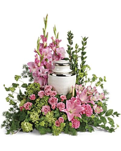 <p>Honor a cherished life with a floral tribute that surrounds the cremation urn with beauty and grace. This heartfelt arrangement offers a meaningful expression of gratitude and remembrance during a difficult time.</p>
<p>The elegant design features a delicate mix of pink blooms, including miniature green hydrangea, pink spray roses, Asiatic lilies, alstroemeria, gladioli, and carnations. Accented with green carnations, bupleurum, ivy, myrtle, ming fern, and lemon leaf, the bouquet is rich in texture and color, creating a soft, graceful presence.</p>
<p>Ideal for families and friends seeking to honor their loved one’s memory, this tribute adds a loving and peaceful touch to any cremation service or memorial. Please note this arrangement does not include the urn and is designed to complement it.</p>
<p>Each tribute is handcrafted by expert florists who ensure it arrives fresh and thoughtfully arranged. Same-day delivery is available to provide timely and compassionate service.</p>
<p>Add a personal message to accompany this elegant tribute. This floral arrangement sends a beautiful reminder of love, gratitude, and lasting memory.</p>