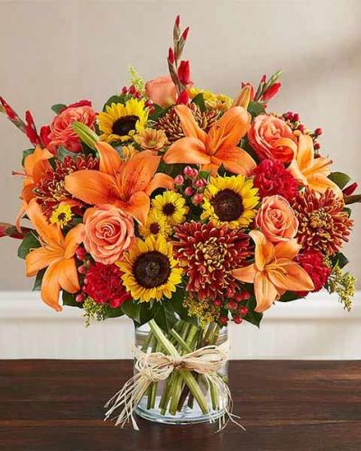 <p>When words fall short, flowers offer a gentle expression of sympathy and remembrance. This fall-inspired arrangement speaks through warm seasonal hues, offering quiet comfort and honoring a life well lived. With its natural beauty and heartfelt presence, it provides a meaningful tribute in moments of sorrow.</p>
<p>The bouquet features a rich blend of golden sunflowers, rust-colored chrysanthemums, deep red carnations, and bronze-hued alstroemeria. These blooms are arranged with seasonal greenery and may include accents like wheat or autumn foliage, bringing texture and warmth to the display. The overall palette evokes the richness of fall and the depth of memory.</p>
<p>This arrangement is appropriate for memorial services, funeral gatherings, or delivery to a loved one’s home. Its colors reflect both the changing season and the enduring spirit of the person it honors, offering peace and reflection through nature’s quiet elegance.</p>
<p>The flowers are presented in a tasteful container that complements the autumn tones and adds grace to any setting. Each bouquet is handcrafted using fresh, seasonal blooms, so flower varieties and colors may vary slightly with availability—ensuring a unique and personal tribute every time.</p>
<p>Share your compassion with a gift that brings solace, beauty, and thoughtful remembrance. This fall arrangement is a sincere expression of sympathy, offering strength and serenity when they are needed most.</p>