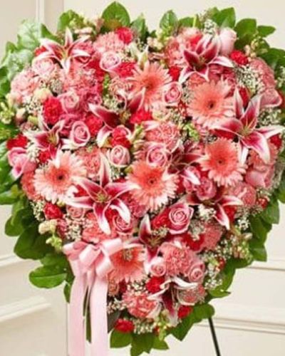 <p>Express your love and heartfelt condolences with a tribute as gentle and beautiful as your memories. The Sympathy & Support Flower Heart in pink is a soft, elegant expression of sympathy, handcrafted to offer comfort and honor a cherished life.</p>
<p>This solid heart-shaped standing spray features a delicate blend of pink roses, stargazer lilies, Gerbera daisies, carnations, and other seasonal blooms. Expertly arranged and tied to a wire easel with a satin ribbon, the piece creates a serene and graceful focal point at any funeral or memorial service.</p>
<p>Appropriate for close family members and friends, this arrangement is a timeless way to express admiration, remembrance, and affection. The soft pink tones symbolize grace, gratitude, and enduring love, making it a comforting and respectful gesture of support.</p>
<p>Each Sympathy & Support Flower Heart in pink is carefully handcrafted by expert florists with attention to detail. Same-day delivery is available to funeral homes and memorial venues throughout the local area, ensuring every detail is handled with care.</p>
<p>Add a personal message at checkout to accompany your floral tribute. Let this beautiful heart arrangement help you honor their memory with love, softness, and sincere support.</p>