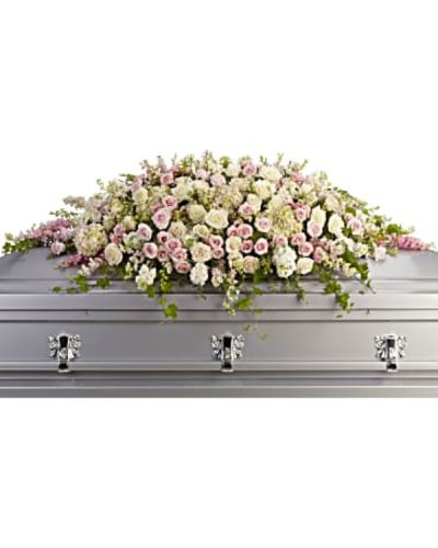 <p>Honor a radiant life with a stunning casket spray that conveys timeless love, beauty, and peace. Soft in tone and elegant in form, this lush floral cascade offers a heartfelt tribute to someone cherished beyond words. Its gentle colors and graceful shape provide comfort during a time of sorrow while celebrating a life filled with warmth and grace.</p>
<p>This exquisite spray is composed of pale pink hydrangea, blush and white roses, and delicate pink larkspur. White stock and soft waxflower add gentle texture, while trailing ivy, parvifolia eucalyptus, and leatherleaf fern bring movement and natural elegance. The entire arrangement rests atop the casket in a flowing, symmetrical design that speaks to enduring love and admiration.</p>
<p>This spray is an ideal choice for honoring a beloved mother, grandmother, sister, daughter, or dear friend. The soft palette of pink, white, and crème represents grace, compassion, and lasting affection—an expression of love that remains even in farewell.</p>
<p>Each spray is handcrafted with care by expert florists. Same-day delivery is available to funeral homes and memorial venues to ensure your tribute arrives fresh, full, and ready to honor the occasion with dignity and care.</p>
<p>Include a personal message at checkout to share your thoughts, memories, or condolences. Express love and remembrance with a timeless floral tribute that honors a life deeply loved.</p>