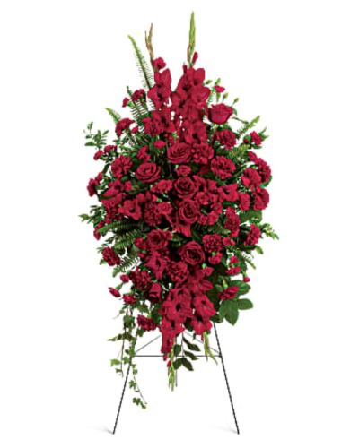 <p>Honor a cherished life with a rich and elegant standing arrangement composed of deep red blooms that express enduring love, respect, and heartfelt sorrow. Designed to stand proudly at the service, this sympathy spray is a timeless gesture of remembrance, offering comfort to grieving hearts and celebrating a life deeply loved.</p>
<p>This striking arrangement features a lush selection of premium red roses, accented by complementary red blooms such as carnations, snapdragons, and alstroemeria. Each flower is chosen for its beauty and symbolism, with red representing devotion, strength, and lasting affection. Touches of greenery, including leatherleaf fern and other fresh foliage, add natural texture and dimension to the design. Mounted on a standing easel, the spray creates a commanding presence at any funeral or memorial service.</p>
<p>This spray is an ideal tribute for a spouse, parent, grandparent, or close friend whose memory will remain forever etched in the hearts of those they touched. Its bold color and graceful shape serve as a visual expression of unwavering love and respect.</p>
<p>Each spray is handcrafted with care and compassion by expert florists. Same-day delivery is available to local funeral homes and memorial venues to ensure that your arrangement arrives fresh, on time, and ready to honor your loved one with dignity.</p>
<p>Include a message of sympathy at checkout to accompany this meaningful floral tribute. Share what words cannot—through flowers that speak from the heart. This spray is a loving tribute that will be remembered.</p>