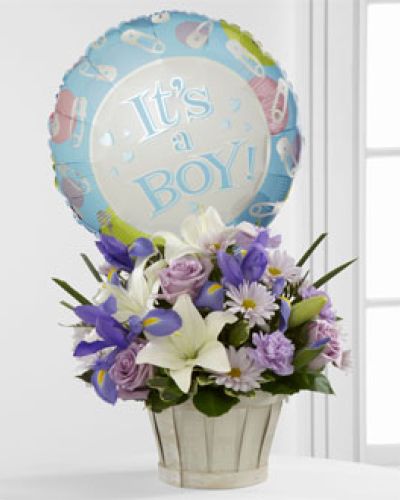 <p>Celebrate the arrival of a baby boy with a bouquet designed to bring joy, calm, and heartfelt congratulations. This charming arrangement offers a gentle mix of color, fragrance, and cheer—perfect for welcoming new life and honoring the happiness of a growing family. Its thoughtful design captures both the tenderness and excitement of such a meaningful occasion.</p>
<p>The bouquet includes a balanced blend of lavender roses, soft lavender daisies, ruffled carnations, white Asiatic lilies, and bold blue iris. Each flower is chosen for its beauty and symbolic meaning, creating a fresh and elegant combination of soft and vibrant tones. Lush greenery adds texture and fullness, while the flowers are presented in a whitewash woodchip basket that brings a rustic, natural touch to the arrangement.</p>
<p>Adding a playful note to the bouquet is a festive “It’s a Boy!” Mylar balloon that floats gently above the flowers. This cheerful detail helps mark the moment with a joyful flair, making the arrangement ideal for welcoming a newborn at home, in the hospital, or at a baby shower. The combination of soothing hues and celebratory elements makes this gift both comforting and memorable.</p>
<p>Perfect for new parents, grandparents, or friends looking to share in the joy, this bouquet brings beauty to any nursery, living room, or kitchen table. Its cool lavender and blue tones promote a sense of calm, while the overall freshness of the blooms offers a reminder of new beginnings. This floral tribute is a sincere way to say, "We're so happy for you."</p>
<p>Let this bouquet serve as a loving gesture that honors the newest addition to the family. With its soft colors, graceful textures, and heartfelt presentation, it expresses your warm wishes in a way that will be remembered long after the flowers have faded.</p>