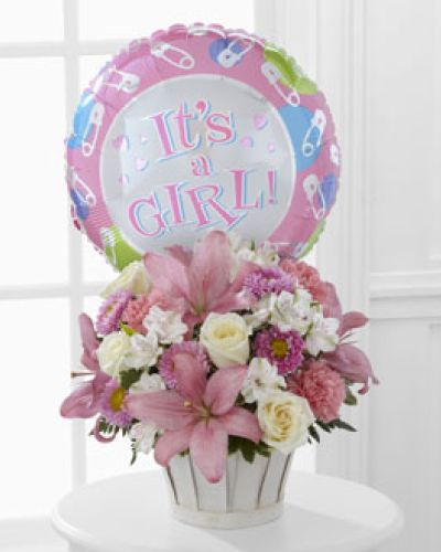 <p>Nothing captures the joy of new life quite like a beautiful bouquet filled with soft colors, fresh fragrance, and heartfelt warmth. This cheerful arrangement is designed to welcome a baby girl into the world with love, grace, and a sweet touch of celebration. It's a thoughtful way to mark the occasion and share in the happiness of a growing family.</p>
<p>The bouquet includes a tender blend of white roses, white Peruvian lilies, pink carnations, matsumoto asters, and pink Asiatic lilies. Each bloom is carefully selected for its freshness and symbolic meaning, creating a design that feels both joyful and serene. Lush greenery frames the flowers with natural softness, and the entire arrangement is presented in a round whitewash woodchip basket that adds rustic charm and timeless appeal.</p>
<p>Adding to the festive spirit is a whimsical “It’s a Girl!” Mylar balloon that floats above the bouquet. This playful accent brings an extra smile to the moment, making it ideal for delivery to a home, hospital room, or baby shower venue. The overall design is both welcoming and heartwarming, offering a memorable way to celebrate the arrival of a precious new life.</p>
<p>This bouquet makes a meaningful gift for parents, grandparents, extended family, or friends eager to share their congratulations. With its soft pink and white hues, it brings peace and sweetness to any nursery, living space, or kitchen table. The gentle fragrance and thoughtful presentation provide a comforting presence and a visual reminder of joy during those first unforgettable days.</p>
<p>Let this charming bouquet help celebrate the arrival of a baby girl with beauty and love. Its delicate design and festive finishing touches make it a tender gesture that honors this special moment with sincerity and grace.</p>
